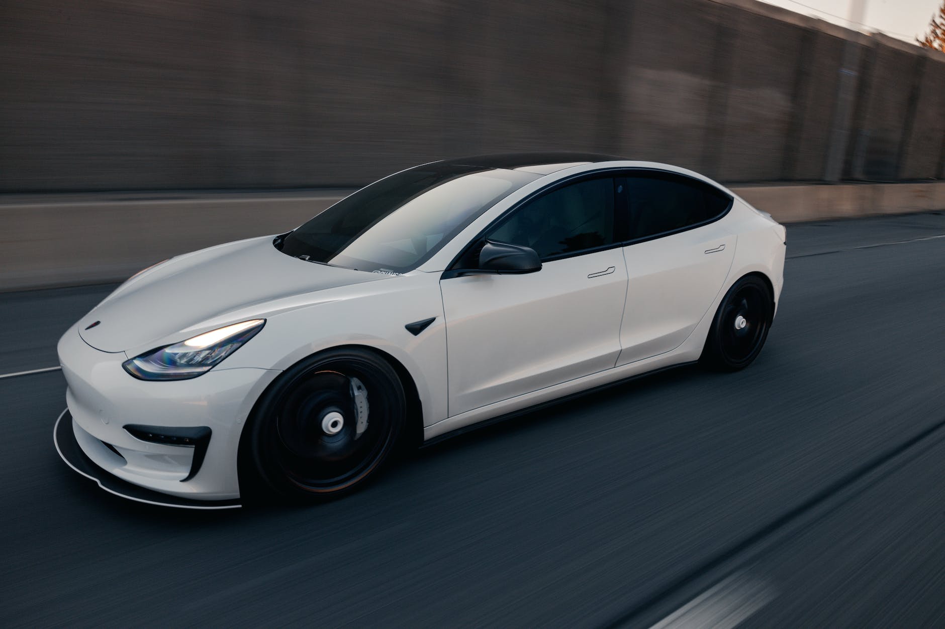 a white tesla car on a road