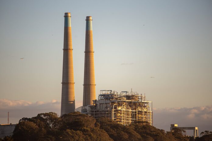 photo of a factory at sunset