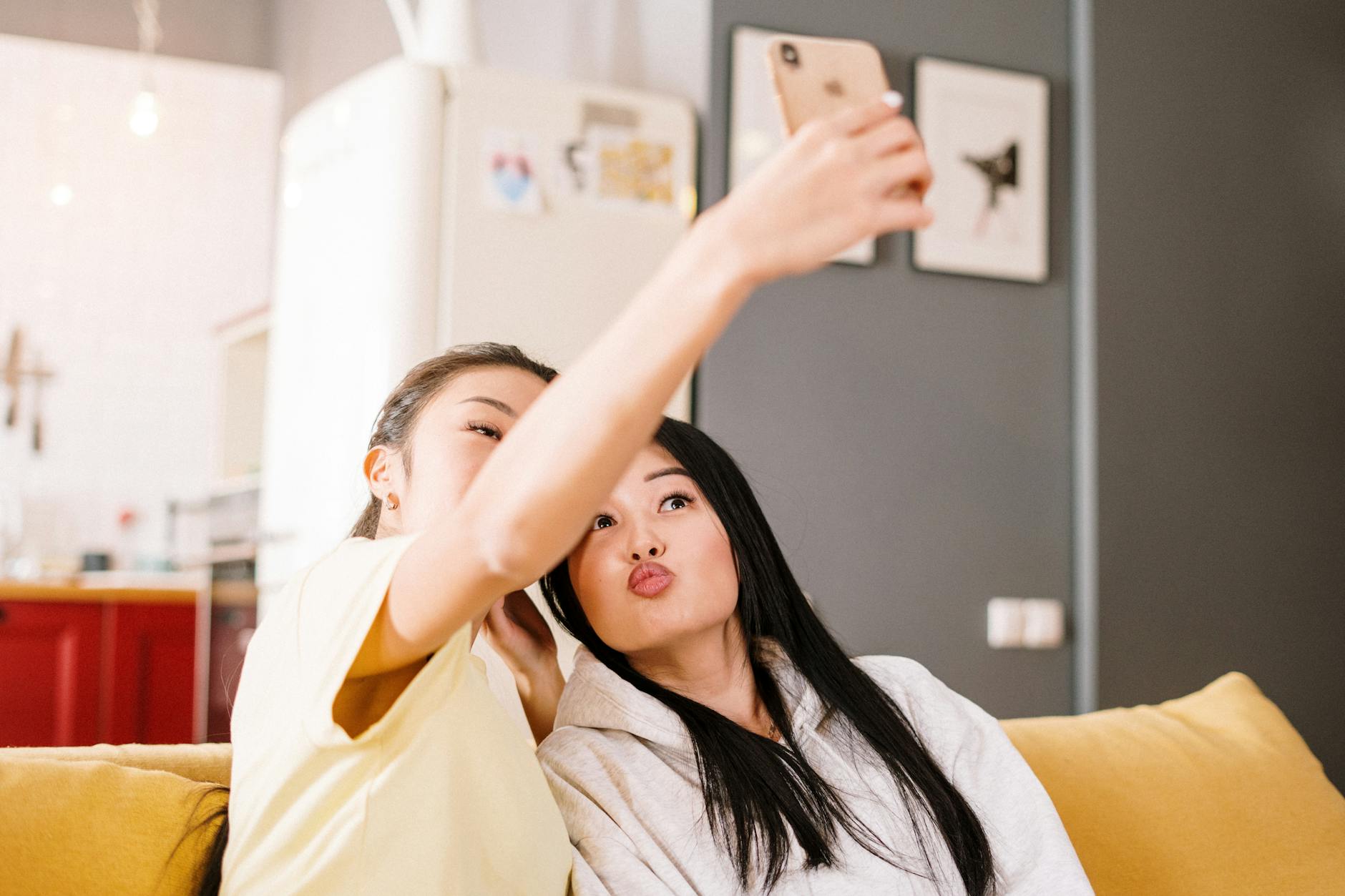 woman in white shirt holding her face