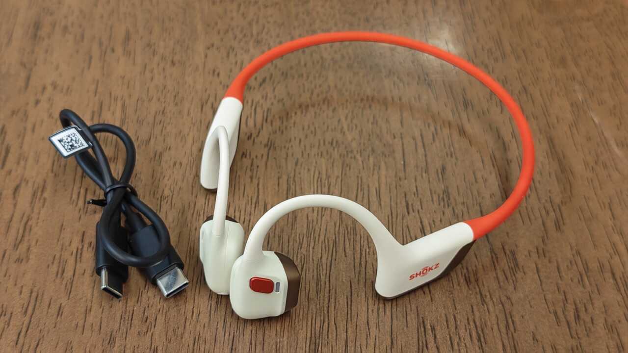耳機企喺木面上,旁邊係黑色 USB-C 線